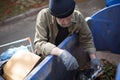 Top view of tramp rummaging in trash can. Royalty Free Stock Photo