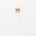 Top view of transparent empty glass jar or test tube bottle with closed brown cork cap lids on white background Royalty Free Stock Photo