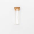 Top view of transparent empty glass jar or test tube bottle with closed brown cork cap lids on white background Royalty Free Stock Photo