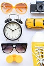 Top view of travel accessories with camera, clock, glasses