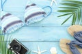 Top view travel banner summer background with palm, starfish, shells and retro camera. Beach stuff, slippers and bikini