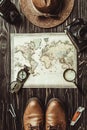 top view of travel setting with straw hat, map, shoes, compass, magnifying glass and photo cameras on dark