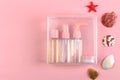 Top view of travel-sized toiletry bottles on pink, ideal for travel and holiday themes. Royalty Free Stock Photo