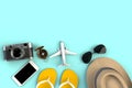 Top view of Traveler`s accessories on blue table background, Essential vacation items, Travel concept