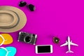 Top view of Traveler`s accessories on pink table background, Essential vacation items, Travel concept