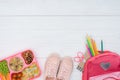 top view of tray with kids lunch, school bag with pencils and shoes Royalty Free Stock Photo