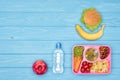 top view of tray with kids lunch for school bottle of water and fruits Royalty Free Stock Photo