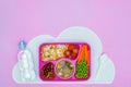 top view of tray with kids lunch for school, bottle of water and plastic spoon Royalty Free Stock Photo