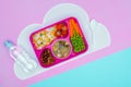 top view of tray with kids lunch for school and bottle of water on violet Royalty Free Stock Photo