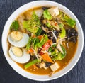 Top view tray of Vietnamese meal for lunch on white background, vegetarian homemade food with seitan fried with citronella, chili Royalty Free Stock Photo