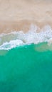 Top view at a tropical beach with waves and blue ocean Drone aerial view at Freedom beach in Phuket