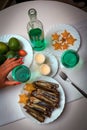 Tropical dinner with carambola, passionfruit, razor clam shells, green wine and two candles