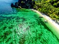 Top view of a tropical island with palm trees and blue clear water. Aerial view of a white sand beach and boats over a coral reef Royalty Free Stock Photo