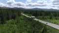 Top view of truck driving along highway on summer day. Scene. White truck is driving on country highway with green Royalty Free Stock Photo