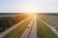Top view of trucks and cars moving along an asphalt road in the rays of sunset Royalty Free Stock Photo
