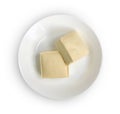 Top view of two blocks of white tofu with plate isolated on white