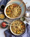 Top view of two bowls of delicious ramen with chopsticks on the table