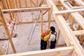 Top view on two engineers builders working together, building wooden cottage house. Royalty Free Stock Photo