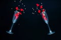 Top view on two champagne glasses with red heart on black background. Happy valentines day dinner. Royalty Free Stock Photo