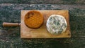 Top view of two cheeses on a wooden board on a rustic table. Smoked cheese and moldy blue cheese Royalty Free Stock Photo