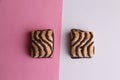 Top view of two chocolate biscuits isolated on a pink and white background Royalty Free Stock Photo