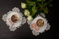 Top view of two cups of coffee with milk, Turkish delight on a saucer, white roses. Royalty Free Stock Photo