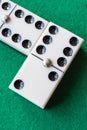 Top view of two domino pieces on green mat Royalty Free Stock Photo