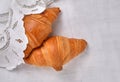 Top view on two fresh croissants on white vintage background