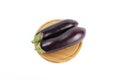 Top view of two fresh eggplants on a wooden plate isolated on a white background Royalty Free Stock Photo