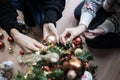 Top view of two girlfriends decorating holiday tree together