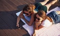 Top view of two girls on the beach that lying down on the ground and enjoying warm sunlight Royalty Free Stock Photo