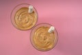 Top view of two glasses of popular Korean Dalgona coffee on pink background. Made at home Royalty Free Stock Photo