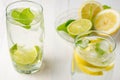 Top view of two glasses of water with lemon and lime slices with ice cubes on white wood Royalty Free Stock Photo