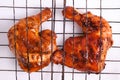 Top view of two Grilled chicken legs soy sauce, coriander, and garlic seasoning on a grilling rack Royalty Free Stock Photo