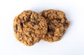 Top view of two homemade oatmeal raisin cookies on a white plate illuminated with natural light Royalty Free Stock Photo