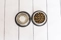 Top view of two metal bowls, one with dog food and the other with water. Pets indoors. Home or studio. Love for animals concept Royalty Free Stock Photo