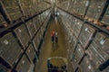 Top view of two people in megastore with lots of containers on the shelves