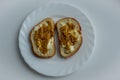 Top view of two pieces of bread with wholegrain mustard and butter on white plate Royalty Free Stock Photo