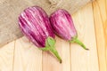 Uncooked Graffiti eggplants on a wooden surface