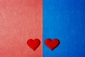 Top view of two red hearts in blue and pink color cardboard background Royalty Free Stock Photo