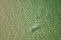 Top view of two swimmers, a boy and a girl in a turquoise sea Royalty Free Stock Photo