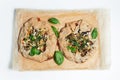 Top view of two vegan galettes on parchment paper. White background. Homemade food.