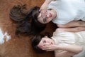 Top view of two women put hand to cover their eye and laying on natural cow skin carpet / fashion concept / beauty blogger /
