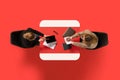 Top view. Two young business ladies sitting at common table with documents and discussing work issues against red Royalty Free Stock Photo