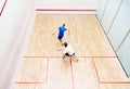 Top view of two young men, friends, sportsmen playing squash on squash court. Competition Royalty Free Stock Photo