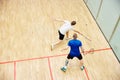 Top view of two young men, friends, sportsmen playing squash on squash court. Competition. Dynamics Royalty Free Stock Photo