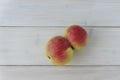 Top view of ugly red and yellow apple - two apples are connected in one, unusual strange shape of fruit, Royalty Free Stock Photo