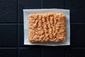 A top view of a raw chicken mince on placed on the white napkin  on the black table Royalty Free Stock Photo