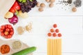 Top view of uncooked pasta with tomatoes and fresh raw vegetables Royalty Free Stock Photo