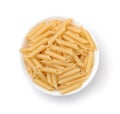 Top view of uncooked penne lisce pasta in bowl